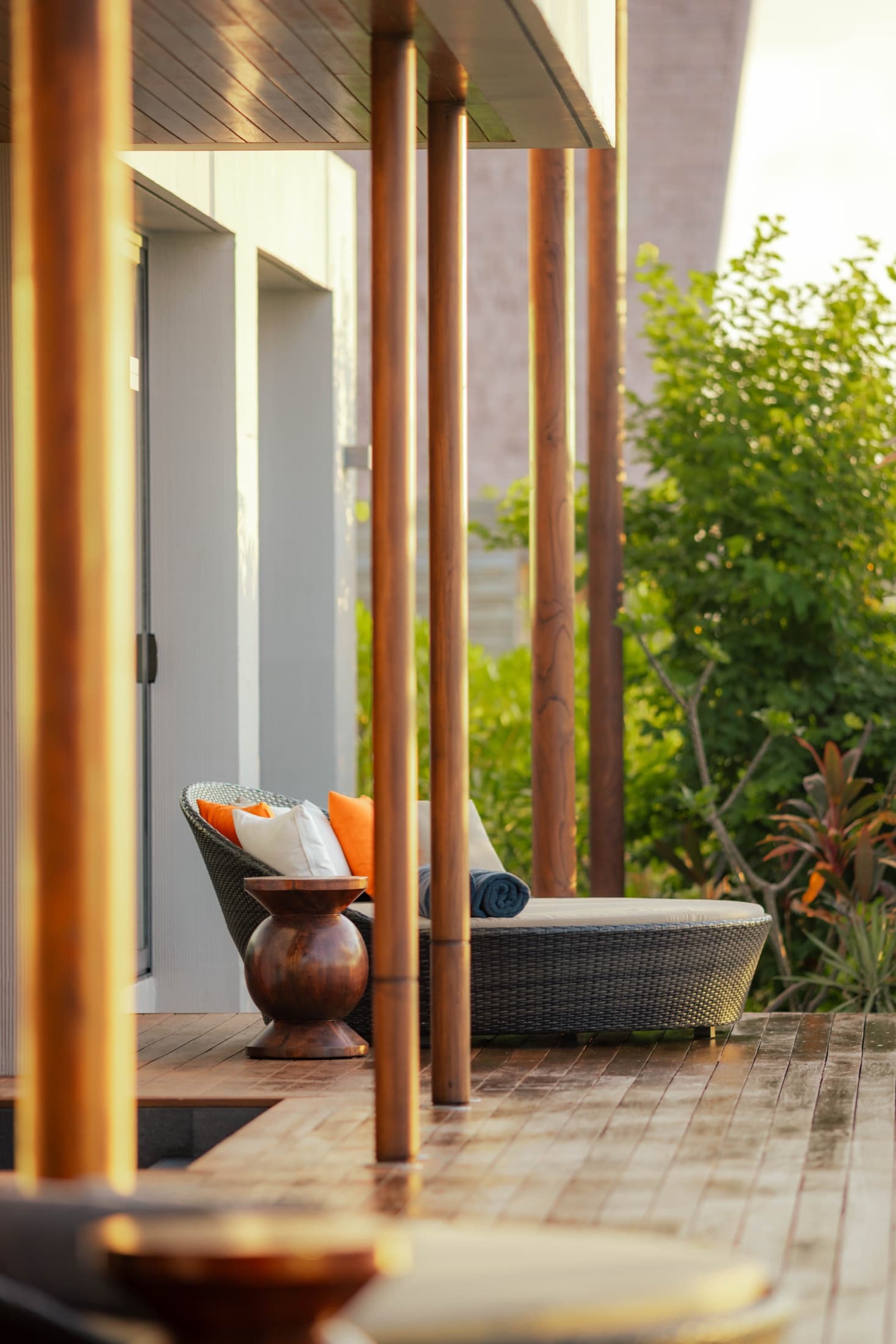 A shaded villa terrace with a daybed